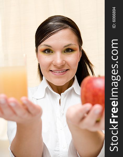 Attractive brunette woman holding apple. Attractive brunette woman holding apple