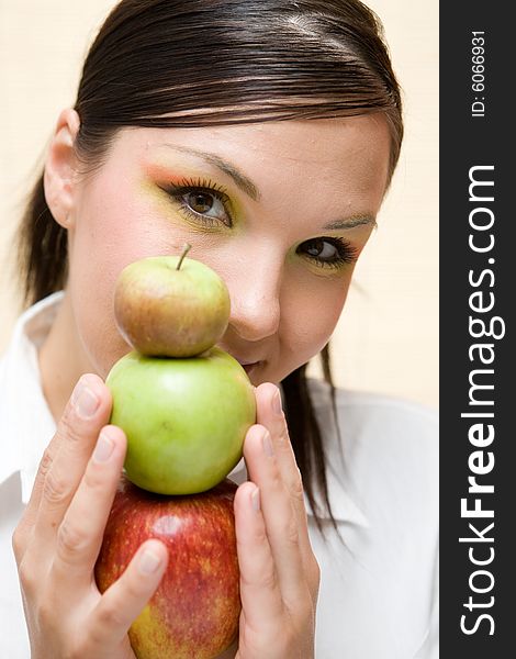 Attractive brunette woman holding apple. Attractive brunette woman holding apple