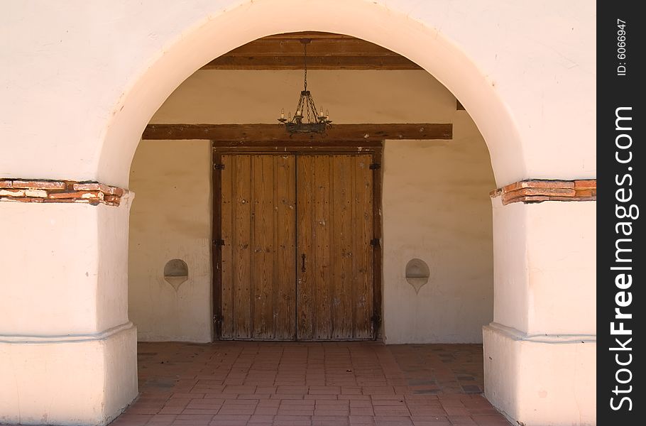 The arch and doorway of a very old Spanish mission. The arch and doorway of a very old Spanish mission