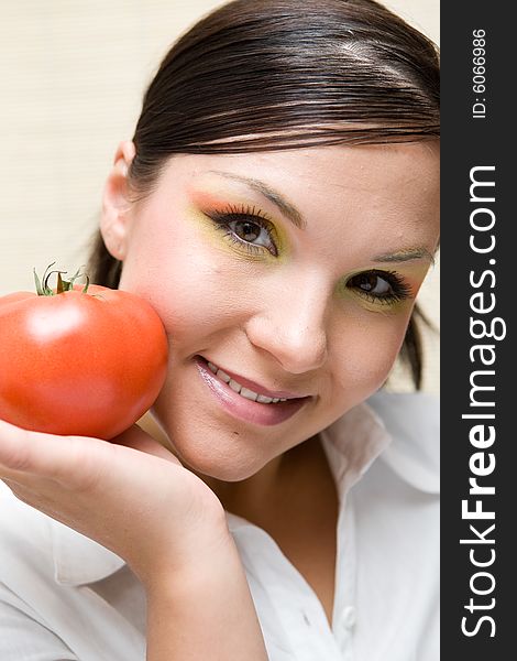 Attractive brunette woman holding vegetable. Attractive brunette woman holding vegetable