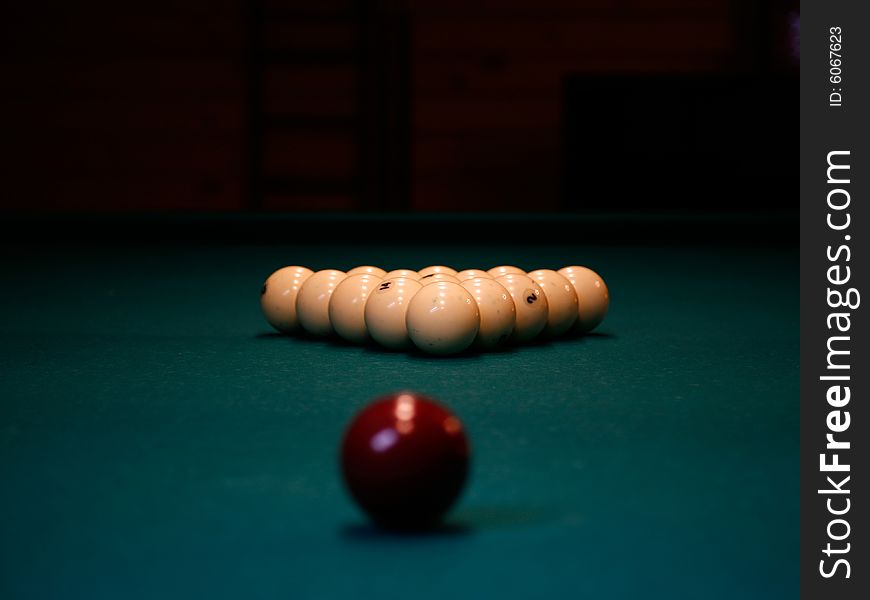 A few pool balls in a billiard table