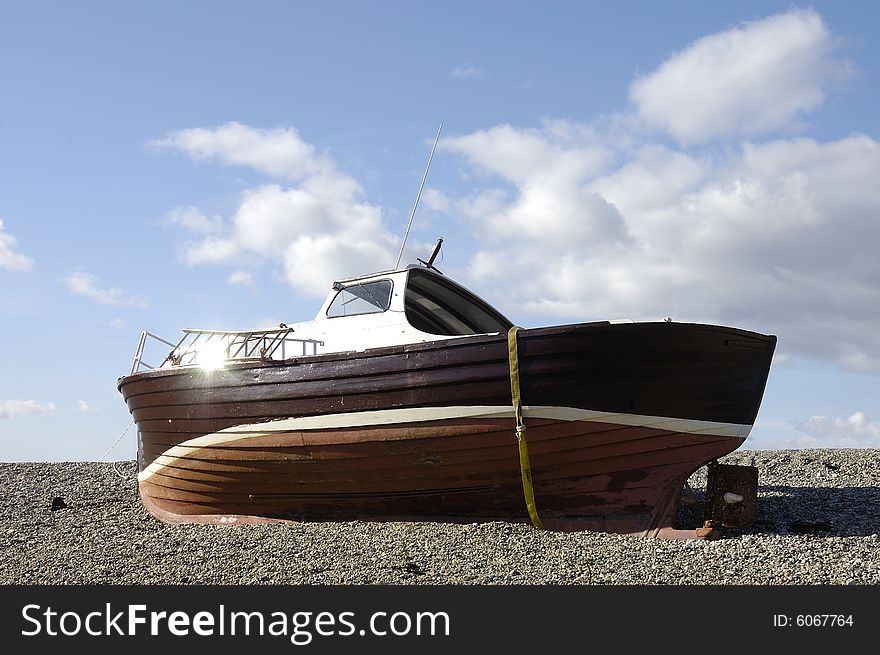 Old beached fishing boat rotting away. Old beached fishing boat rotting away