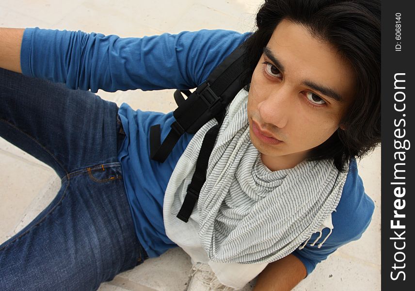 Young Man with a backpack looking up at the camera. Young Man with a backpack looking up at the camera.