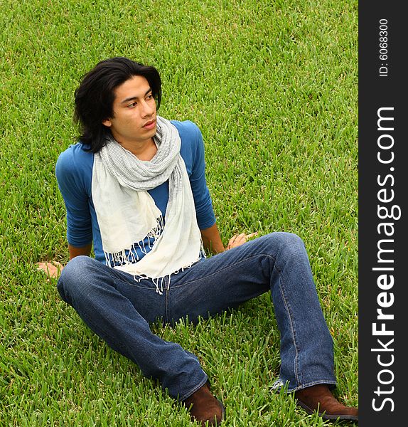 Young man sitting on grass. Young man sitting on grass