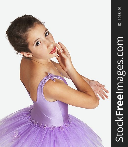 Young beautiful Ballerina with red lips dressed in purple tutu looking sideways in standing position. Young beautiful Ballerina with red lips dressed in purple tutu looking sideways in standing position