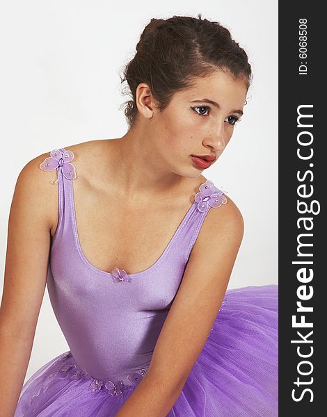 Portrait of Young beautiful Ballerina with red lips dressed in purple tutu looking side ways. Portrait of Young beautiful Ballerina with red lips dressed in purple tutu looking side ways