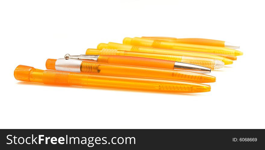 Orange pens on white ground