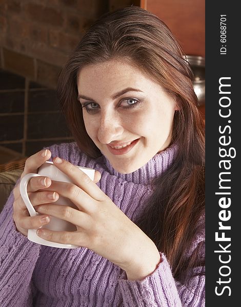 Smiling Girl Holding White Mug With Both Hands