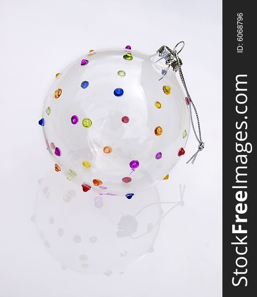 Glass bauble isolated on a white reflective surface. Glass bauble isolated on a white reflective surface.