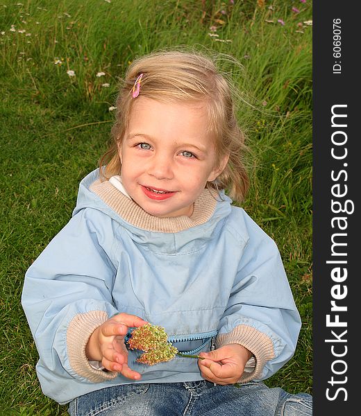 A beautiful 2-year old girl with a flower. A beautiful 2-year old girl with a flower