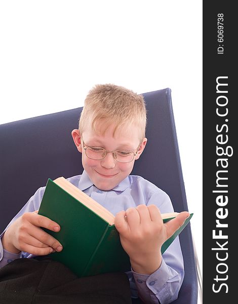 Boy in eyeglasses reading interesting book. Boy in eyeglasses reading interesting book