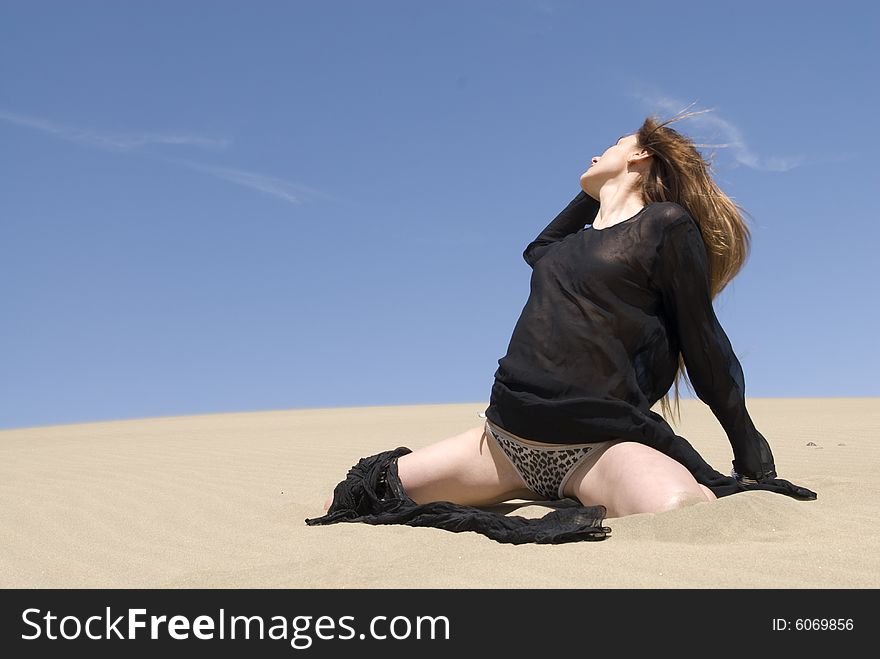 Beautiful Woman In The Dunes Of The Desert