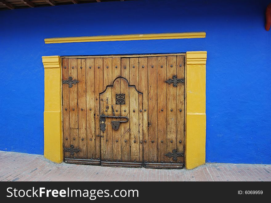 Blue and gold wall and wooden door. Blue and gold wall and wooden door