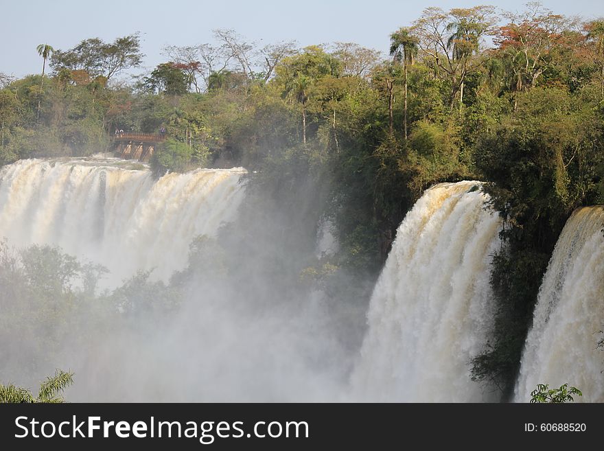 Iguazu falls are waterfalls of the Iguazu River on the border of the Argentine province of Misiones and the Brazilian state of ParanÃ¡. Surroned by rainforest with amazing flora and fauna. Iguazu falls are waterfalls of the Iguazu River on the border of the Argentine province of Misiones and the Brazilian state of ParanÃ¡. Surroned by rainforest with amazing flora and fauna.