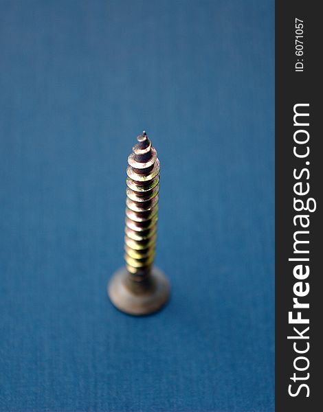 Isolated screw on blue background