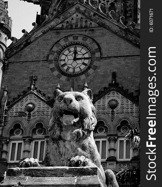 A lion and an old clock in the building showing a speciment of an ancient Indian architecture. A lion and an old clock in the building showing a speciment of an ancient Indian architecture.