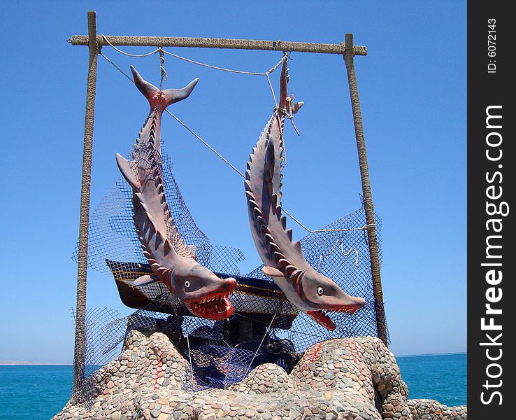 Detail of sculpture dedicated to sharks on funny way, Hurghada