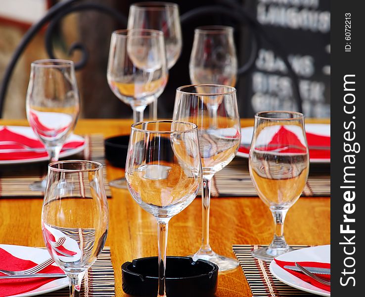 Wineglasses and plates on table in restaurant. Wineglasses and plates on table in restaurant