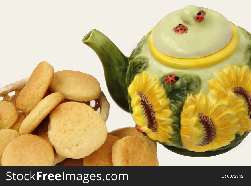 Ceramic teapot and sweet cookies on a white background. Ceramic teapot and sweet cookies on a white background