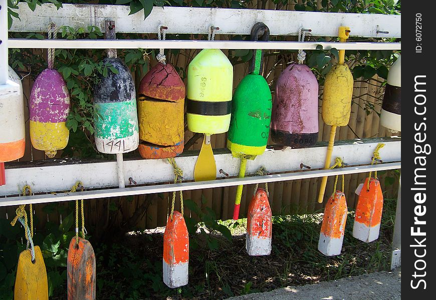 Used buoys hang waiting to be used again showing their colors and skinned paint. Used buoys hang waiting to be used again showing their colors and skinned paint.