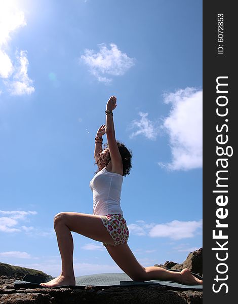 A beautiful woman doing yoga to show a healthy way to live a happy and relaxed lifestyle in a world full of stress. A beautiful woman doing yoga to show a healthy way to live a happy and relaxed lifestyle in a world full of stress