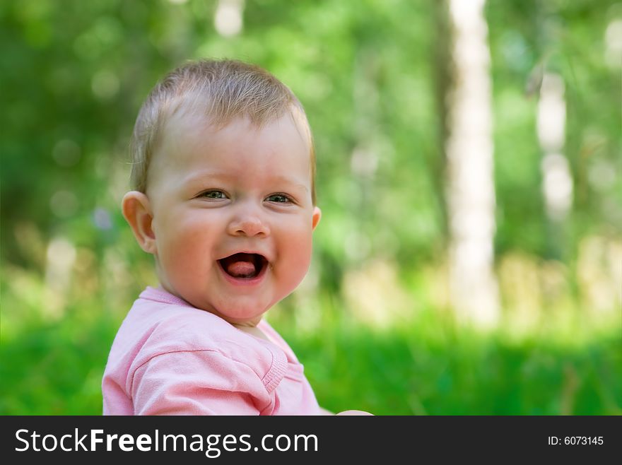 Smiling baby in a wood 2