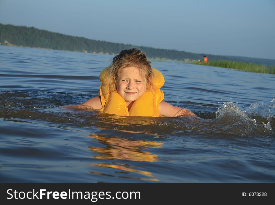 Young girl swimming in river