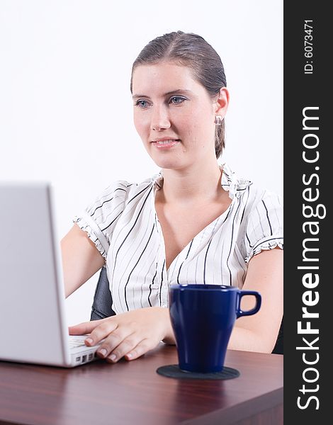 A businesswoman typing information into a laptop computer. A businesswoman typing information into a laptop computer.