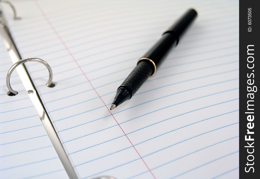 Close up of clasps in 3-ring binder with lined paper. Close up of clasps in 3-ring binder with lined paper