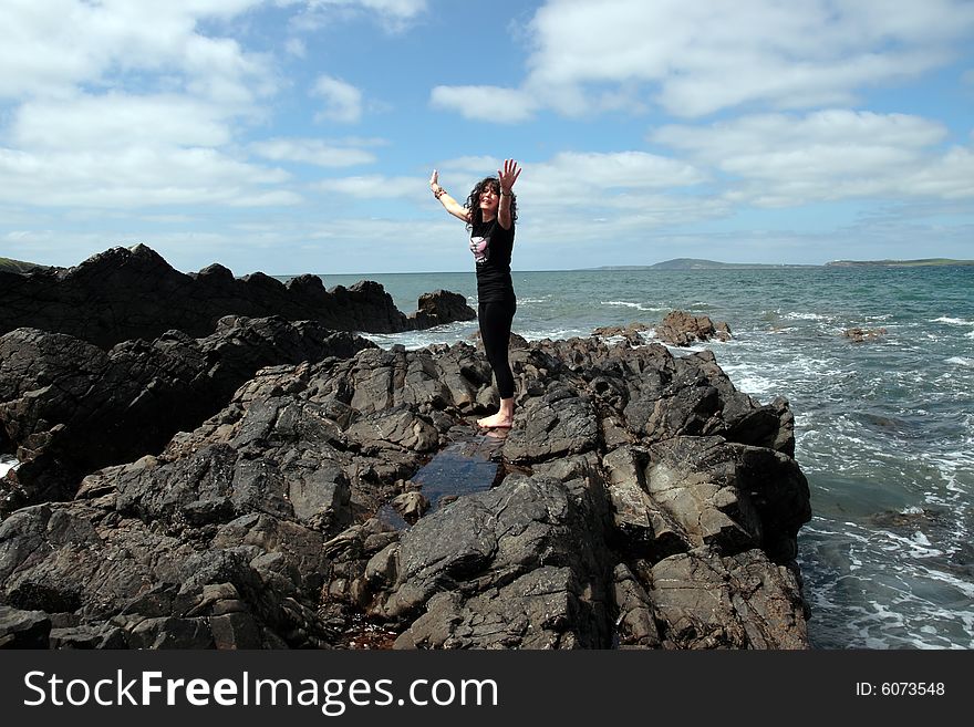 A beautiful woman doing yoga to show a healthy way to live a happy and relaxed lifestyle in a world full of stress. A beautiful woman doing yoga to show a healthy way to live a happy and relaxed lifestyle in a world full of stress