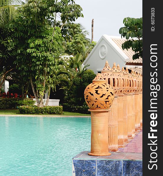 Ceramic decorations next to a swimming pool.