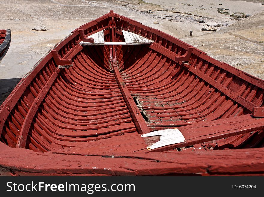 An old abandoned fishing boat, lying on dry dock in Hermanus harbor