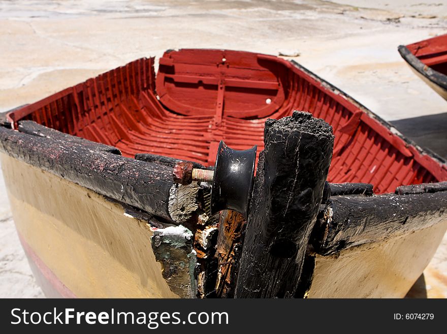 An old abandoned fishing boat, lying on dry dock in Hermanus harbor