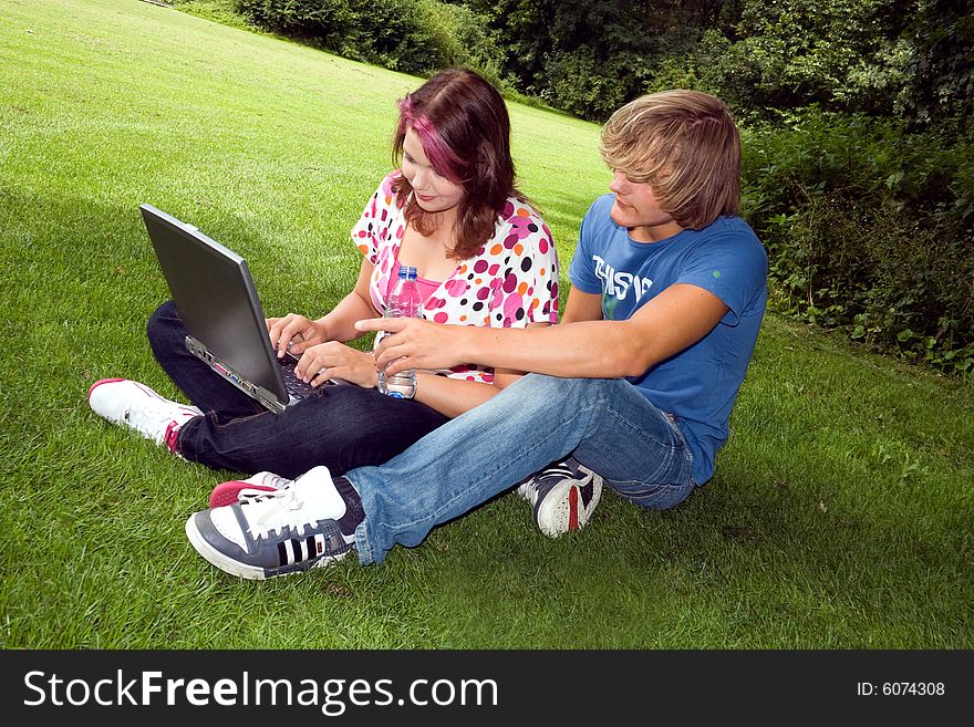 Students studying in a park in the summertime. Students studying in a park in the summertime