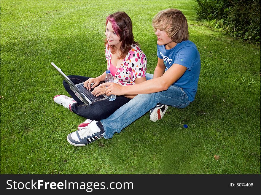 Students studying in a park in the summertime. Students studying in a park in the summertime