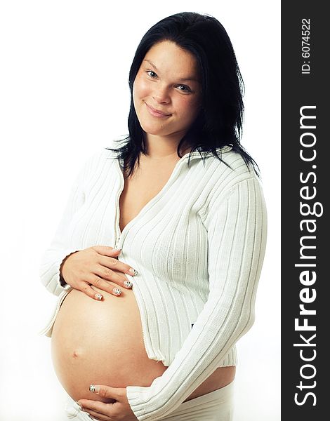 Young cute pregnant woman holding her abdomen. Young cute pregnant woman holding her abdomen.