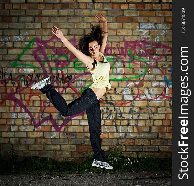 Young cute girl jumping against the wall. Young cute girl jumping against the wall.