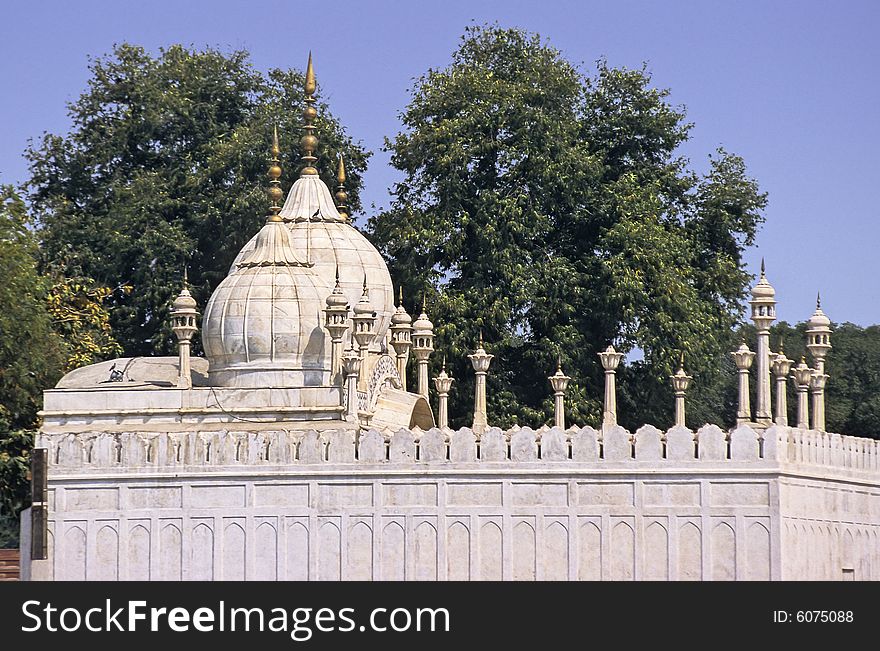 Typical elegant Mogul style white marble mosque with domes and minarets in Red Fort, Delhi, India. Typical elegant Mogul style white marble mosque with domes and minarets in Red Fort, Delhi, India