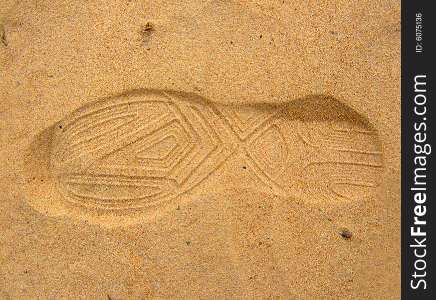 Photo of a trace from a boot on sand. Photo of a trace from a boot on sand.