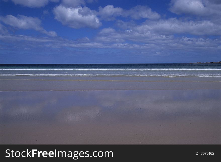 The blue sky,the clouds mirrored on the seaside. The blue sky,the clouds mirrored on the seaside.