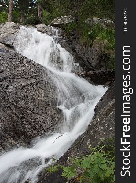 A slow exposure shot of a mountain waterfall