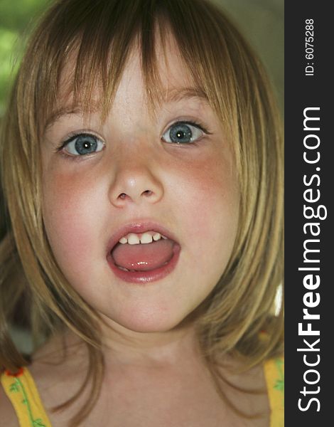 Head shot of little girl talking or singing. Head shot of little girl talking or singing