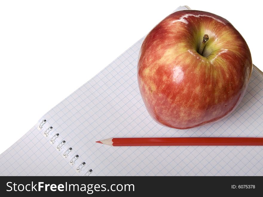 Red apple with notebook and red pencil