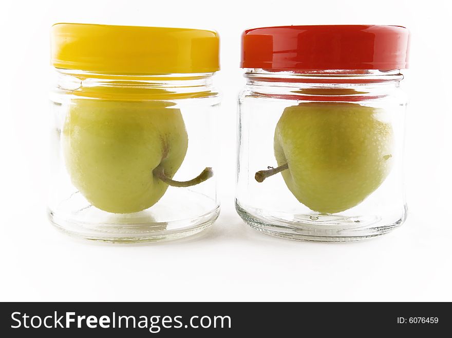 Two apples in jars on white background