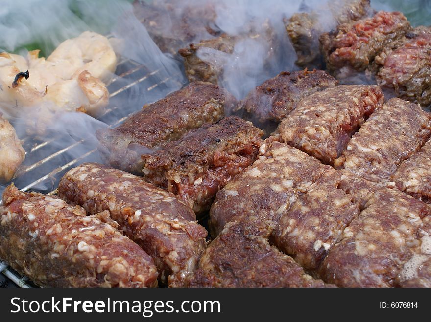 Romanian meat specialities named mici on the barbecue. Romanian meat specialities named mici on the barbecue