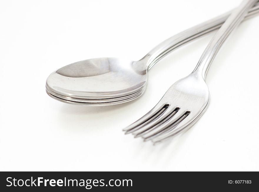 Spoons and forks on white