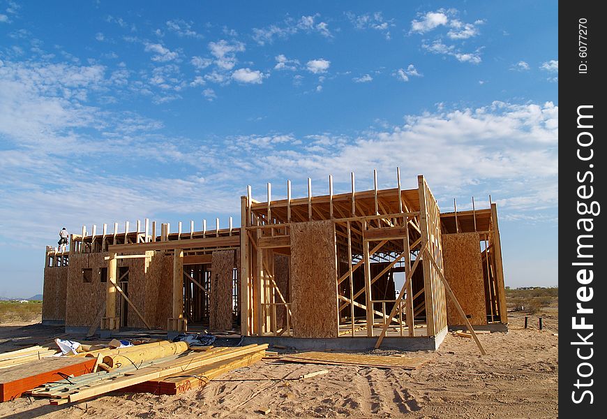 Construction site with an unframed house on it. Horizontally framed photo. Construction site with an unframed house on it. Horizontally framed photo.