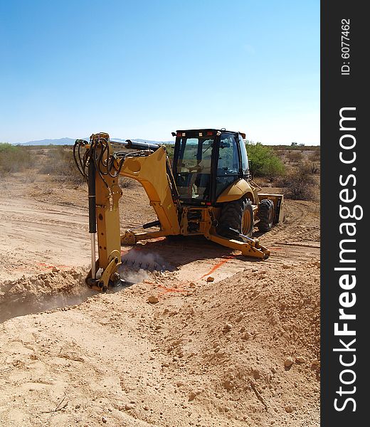 Backhoe in a construction site. Vertically framed photo. Backhoe in a construction site. Vertically framed photo.