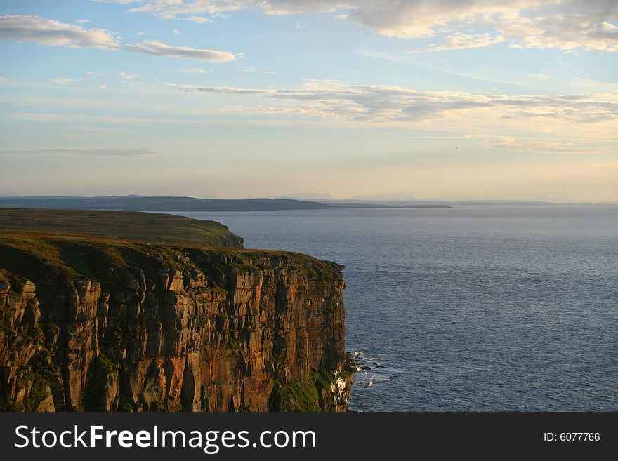 The cliffs and coastline of northern scotland at sunset. The cliffs and coastline of northern scotland at sunset.
