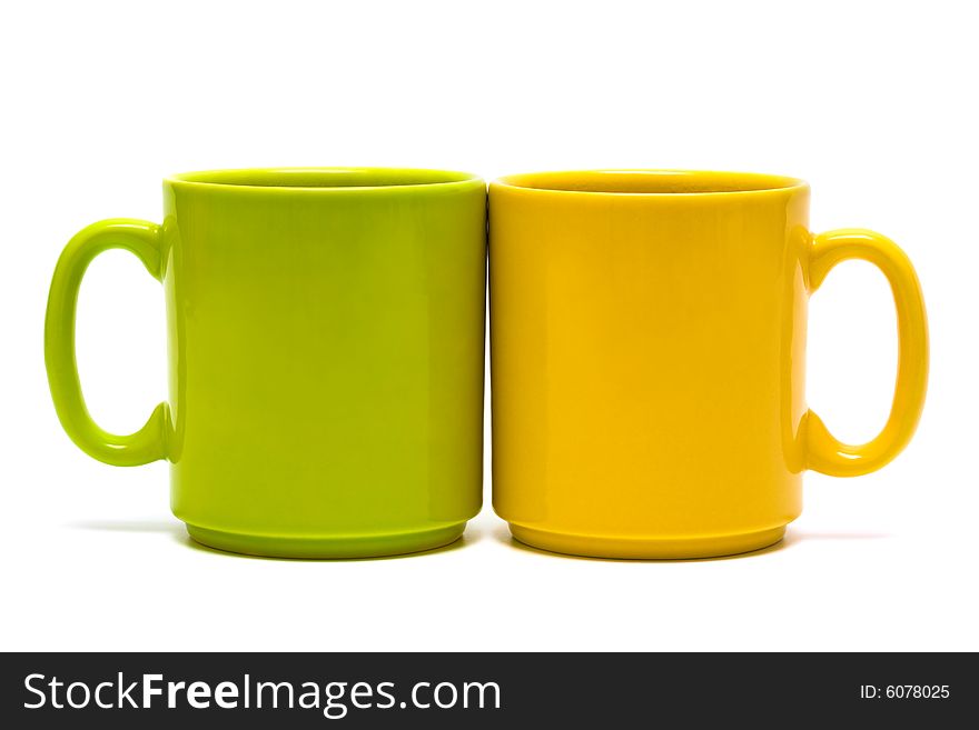 Yellow and green mug on a white background